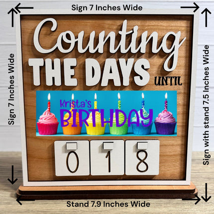 Birthday interchangeable wood countdown sign with cupcake design, personalized name plate, and number tiles. Tabletop sign shows size measurements and stand, handmade decorative calendar for special occasions.