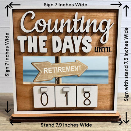 Wooden interchangeable countdown sign displaying “Counting The Days Until” with retirement plate and number tiles showing 018, including measurement details: sign 7 inches wide, stand 7.9 inches wide, and 7.5 inches tall with stand.