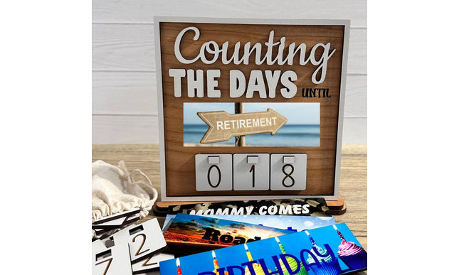 Wooden interchangeable countdown sign displaying “Counting The Days Until” with retirement plate and number tiles showing 018, including measurement details: sign 7 inches wide, stand 7.9 inches wide, and 7.5 inches tall with stand.
