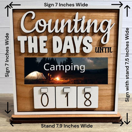Wooden interchangeable countdown sign displaying “Counting The Days Until” with camping plate and number tiles showing 018, including measurement details: sign 7 inches wide, stand 7.9 inches wide, and 7.5 inches tall with stand.