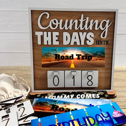 Interchangeable wooden countdown sign displaying “Counting the Days Until Road Trip” with number tiles and additional removable plates.