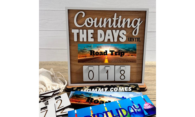 Interchangeable wooden countdown sign displaying “Counting the Days Until Road Trip” with number tiles and additional removable plates.