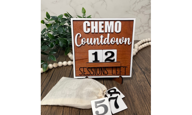 A countdown sign with numbers from 0 to 9 and text that reads 'CHEMO SESSIONS LET' in a natural wood color, accompanied by a storage bag.